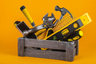 box-with-hand-tool-yellow-background (1)